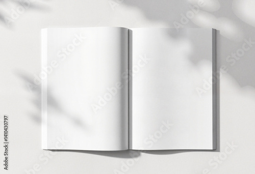 Open blank notebook on a light background with shadows  