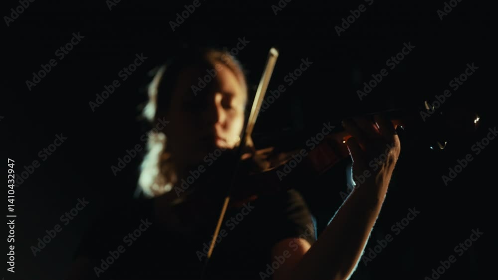Inspiration by rain and night, woman playing violin, silhouette against soffit. Lonely female musician performing beautiful melody by old viola, emotions and feelings of young lady, talented violinist