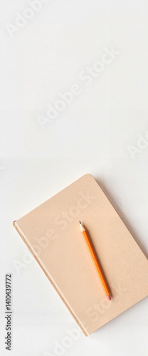 Stylish notebook and orange pencil mockup on clean desk, creativity