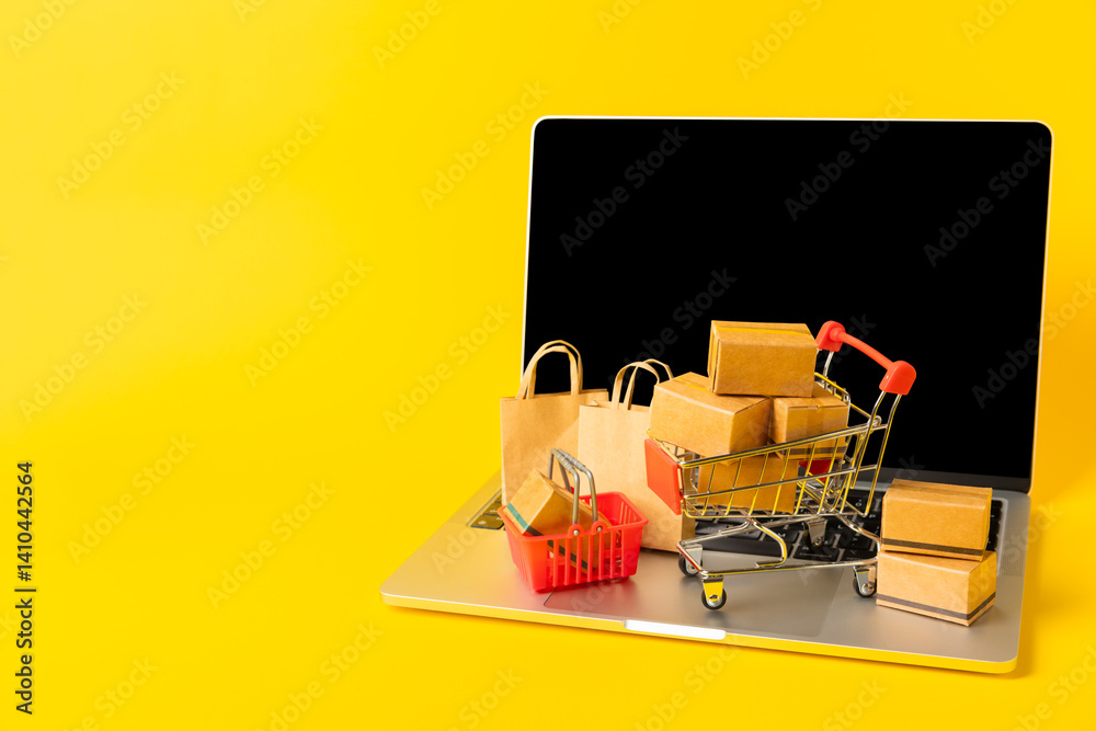 Online shopping concept.Cardboard box and shopping bags in a trolley on a bright colored background. Shopping basket. Online shopping using a laptop, tablet, phone and credit card. Home delivery.