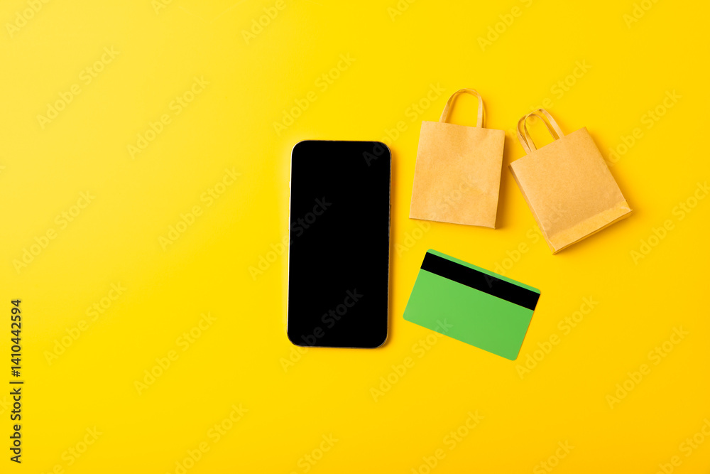 Online shopping concept.Cardboard box and shopping bags in a trolley on a bright colored background. Shopping basket. Online shopping using a laptop, tablet, phone and credit card. Home delivery.