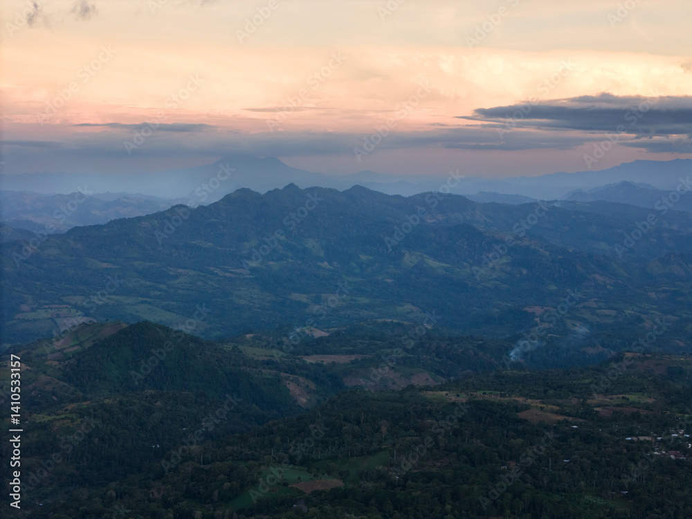 Sunset over mountains and distant hills in serene, scenic view