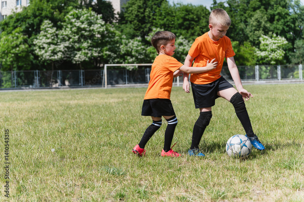 Two boys playing soccer on sunny green field. Two boys playing soccer on sunny green field.