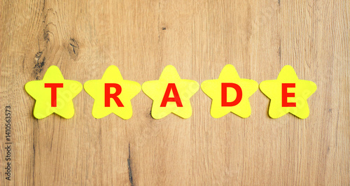 Wallpaper Mural Trade symbol. Concept word Trade on beautiful yellow paper stars. Beautiful wooden table wooden background. Business lifestyle trade concept. Copy space. Torontodigital.ca