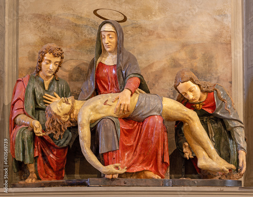 FLORENCE, ITALY - MARCH 18, 2025: The carved polychrome sculptural group of Deposition in the church Chiesa di San Felice in Piazza by Fra Ambrogio dell Robbia (1510) photo