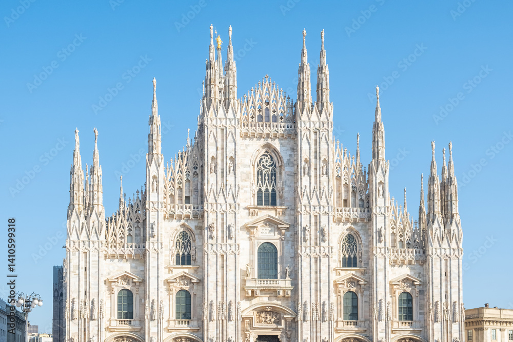 Fototapeta premium Milan Cathedral on Cathedral square in sunny day, Milan, Lombardy, Italy. Piazza del Duomo with Duomo di Milano with intricate Gothic architecture. Travel and touristic landmark