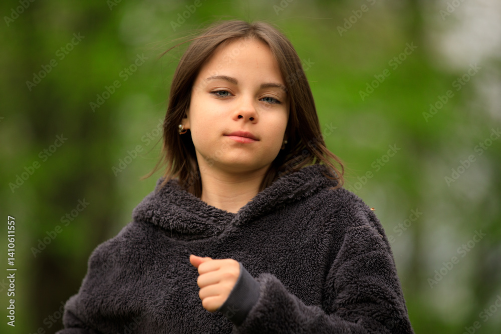 Preteen girl running in park in spring