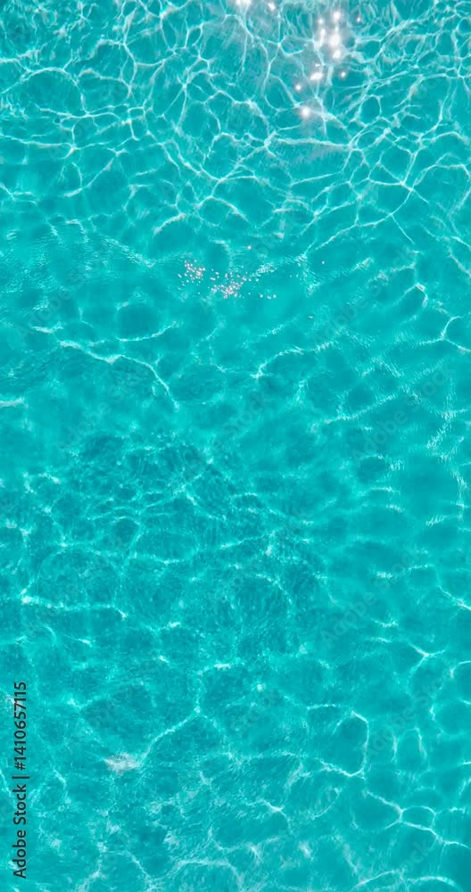 Blue water in the swimming pool with light reflections. Blue water in the swimming pool with light reflections.