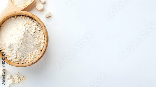 Wooden Bowl Of Flour With Measuring Spoons On White Background