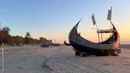 Traditional Sampan fishing boats moored along the shore of the world’s longest sea beach in Cox’s Bazar, Bangladesh
