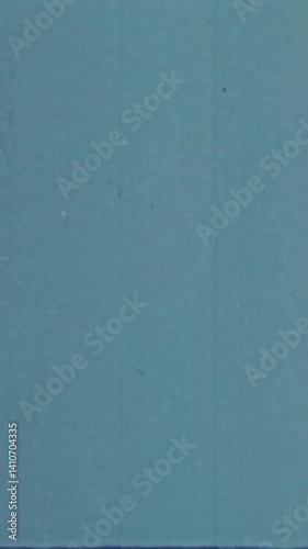 Blue-Tinted Vintage Film Texture Overlay for Vertical Videos. Authentic Analog Look with Dust and Subtle Damage. FL0114