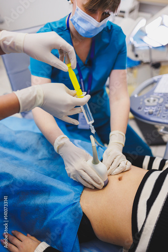 Obraz na płótnie Woman lying near doctor during pregnancy ultrasound. Checking pregnant woman during pregnancy disturbance w salonie