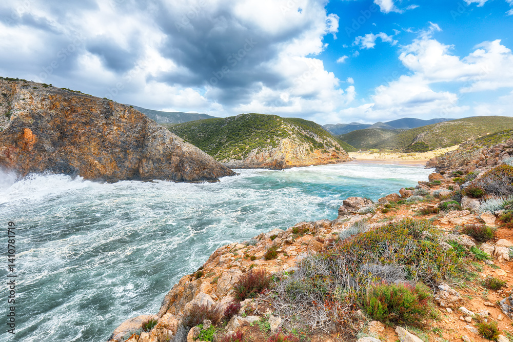 Attractive view of valley Cala Domestica with marvelous sand beach and storm on the sea.
