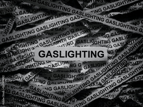 Strips of newspaper with the words Gaslighting typed on them. Black and white.