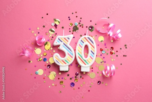 30th birthday. Number shaped candles and confetti on pink background, flat lay