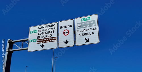 Road signs showing directions to Seville, Ronda, Algeciras and San Pedro de Alcantara in Andalusia, Spain photo