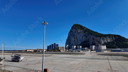 Gibraltar airport runway ending at the Rock of Gibraltar under blue sky