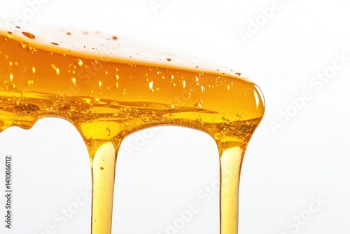 Golden honey dripping, isolated on a white background, showcasing its smooth, rich texture in a food photography shot