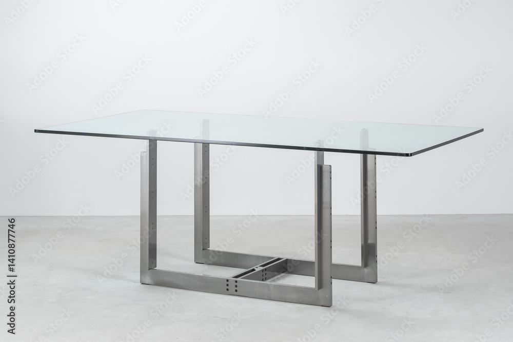 three-quarter view modern table with steel base and glass top three-quarter view modern table with steel base and glass top