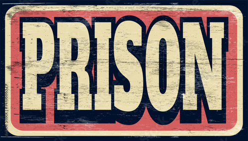Aged and worn prison sign on wood
