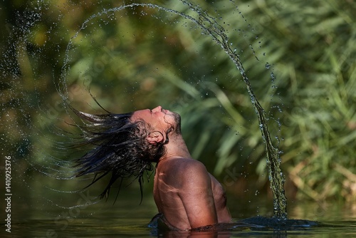 Obraz na płótnie Man whipping wet hair in the lake w salonie