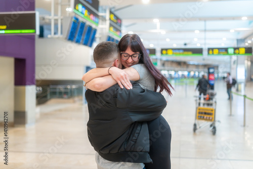 Happy couple embracing at the airport after long time