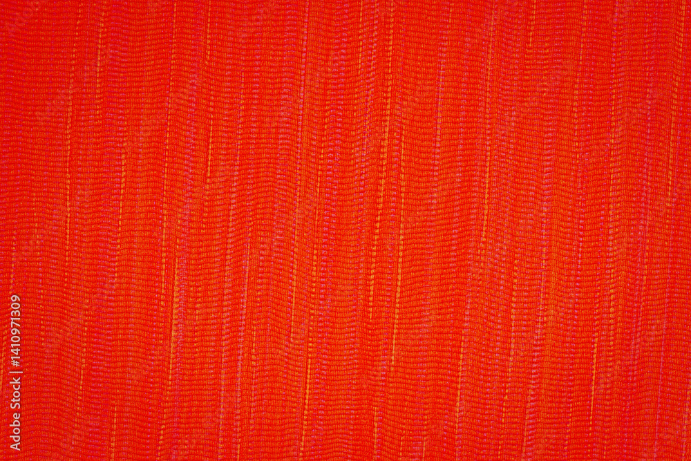 Fototapeta premium Bright red fabric displays a complex texture and pattern, ideal for artistic projects or fashion design applications