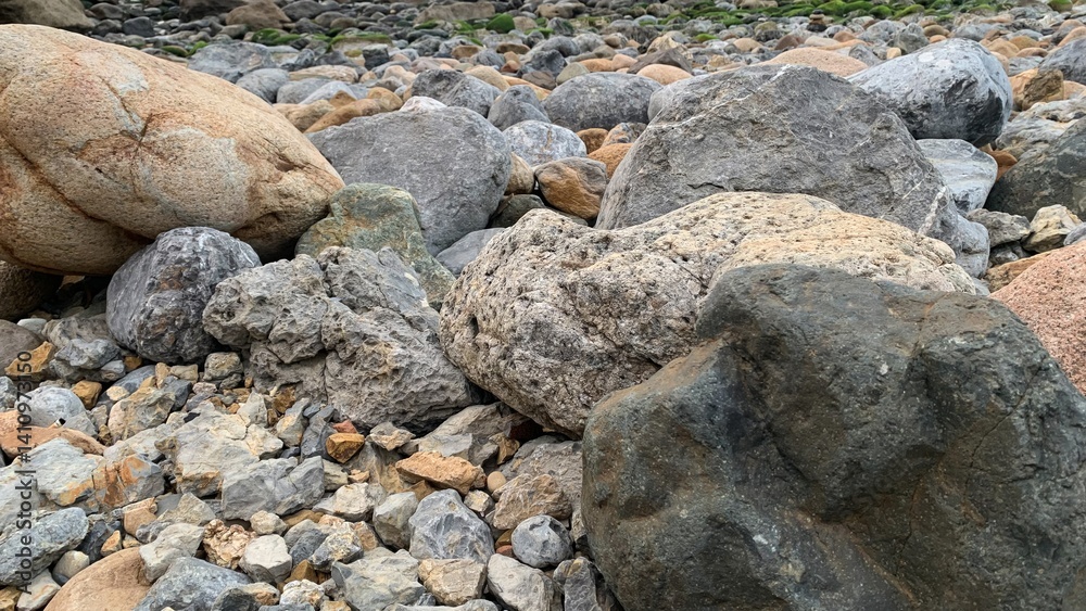 Rugged stones along a rocky shoreline, perfect for nature backgrounds, hiking adventures, and Earth Day promotions Rugged stones along a rocky shoreline, perfect for nature backgrounds, hiking adventures, and Earth Day promotions