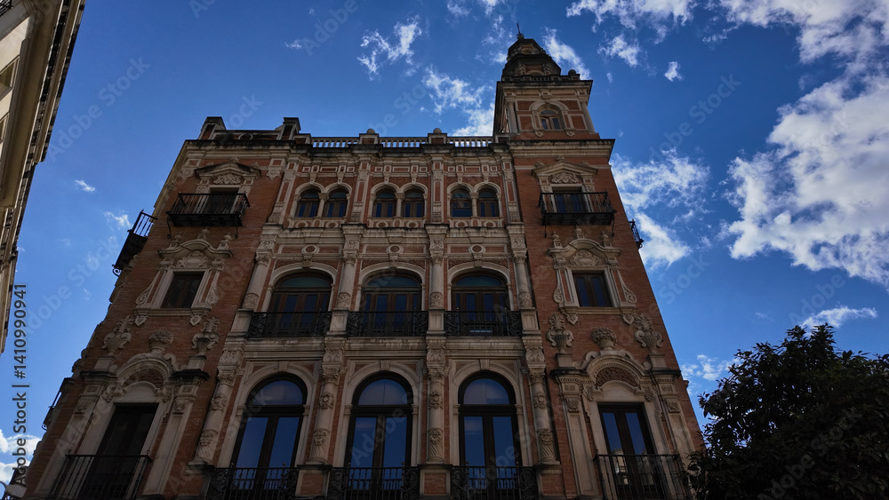 Ornate Building Standing Tall in Seville, Spain, under Blue Sky Ornate Building Standing Tall in Seville, Spain, under Blue Sky