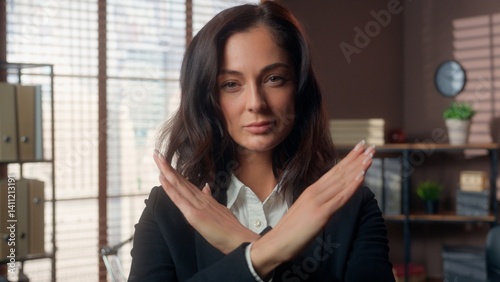 Fotografi Serious Caucasian woman showing gesture hands crossed refusal stop female girl b