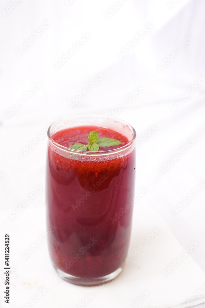 A glass of watermelon juice with ice on a white background. Summer juice concept. Selective focus A glass of watermelon juice with ice on a white background. Summer juice concept. Selective focus