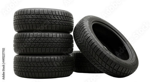 Stack of four black tires with one tire leaning against the stack on a black background scene setting