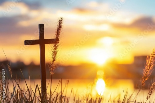 Wooden cross is standing in a field of tall grass