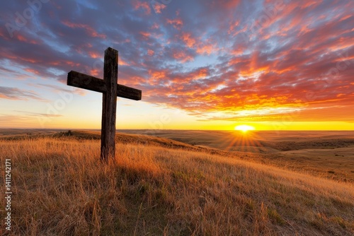 Wooden cross is standing in a field of tall grass