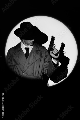 Wallpaper Mural A dark silhouette of a male detective in a coat and hat with a gun in his hands in the noir style. A dramatic portrait in the style of detective films of the 1950s. The silhouette of a spy in a circle Torontodigital.ca