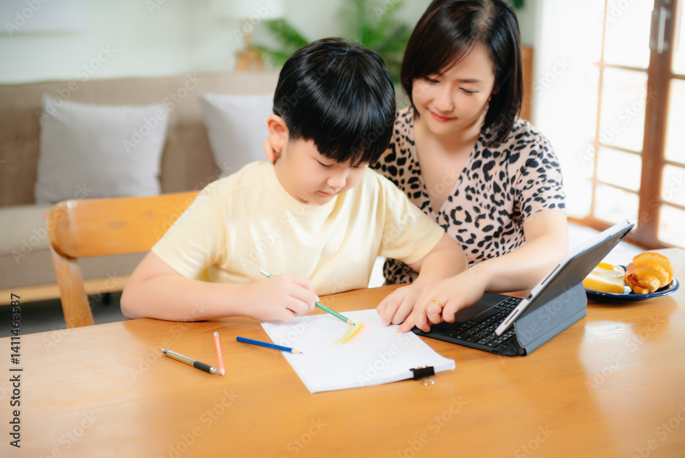 Asian mom and son relaxing at home, smiling, bonding over smartphone, laptop, and tablet. Fun digital lifestyle Asian mom and son relaxing at home, smiling, bonding over smartphone, laptop, and tablet. Fun digital lifestyle