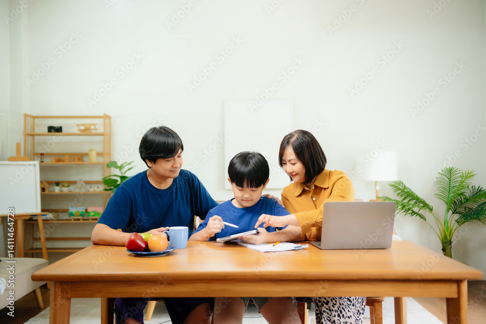 Homeschool Asian young little boy learning online and does homework by using computer and tablet with mother help, teach and encourage. Homeschool Asian young little boy learning online and does homework by using computer and tablet with mother help, teach and encourage.