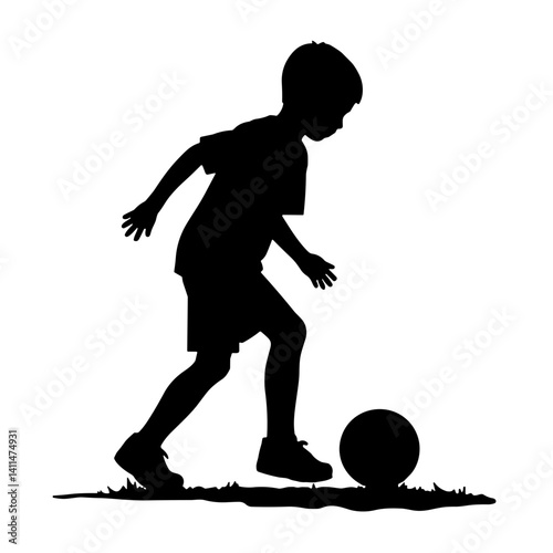 Silhouette of child playing soccer on green grass