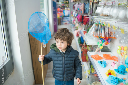 Boy with net in a colorful toy store