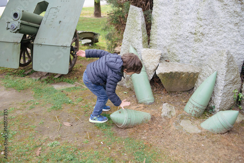 Kid exploring park's artillery display