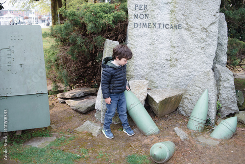 Child explores historical war relics in a park