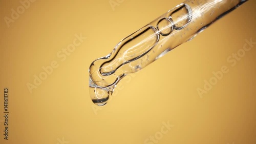 Glass pipette with facial serum on a light background. Essential oil close-up in a pipette. A skin care product with hyaluronic acid in a pipette.