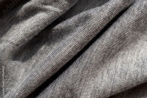 Foto Gray knitted fabric close up. Copy space.