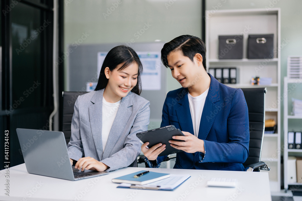 Fototapeta premium Kind leader executive manager share and discuss business solutions plan ideas on tablet with Asian female marketing manager