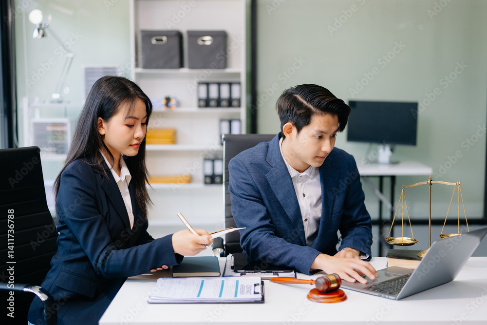 Fototapeta premium Asian business team and lawyers discussing contract papers sitting at the table. Concepts of law, advice, legal services.