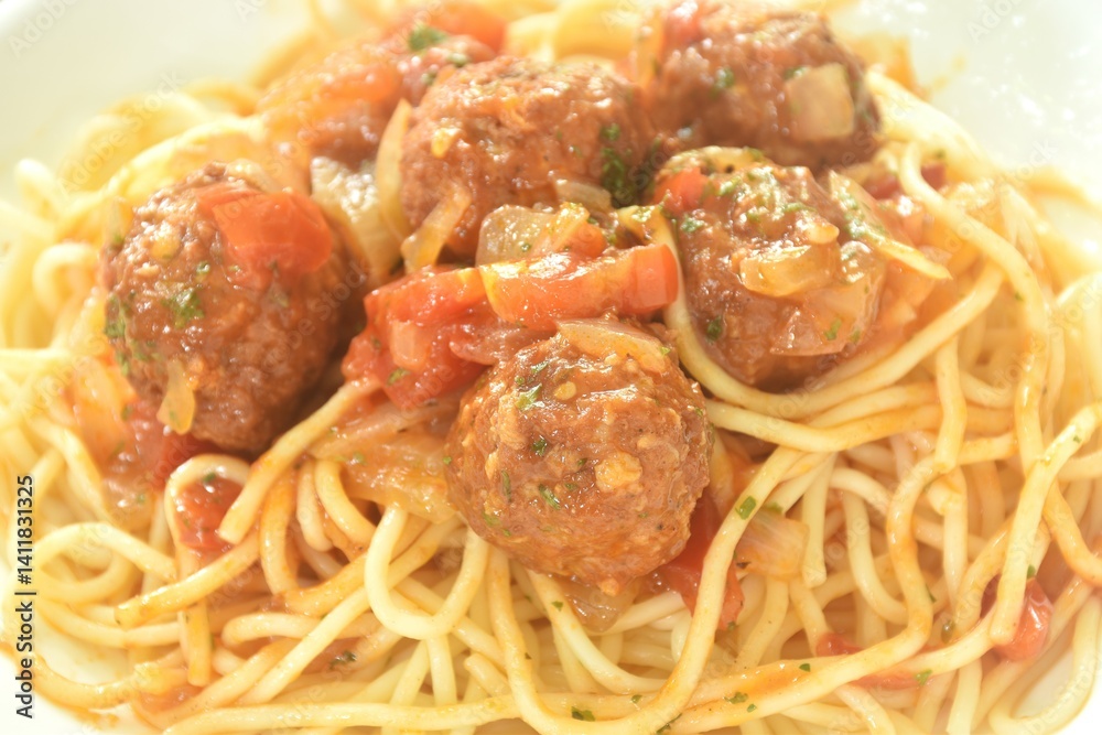 spaghetti dressing fried meatball stuffed cheese in chop onion and tomato ketchup sauce on plate