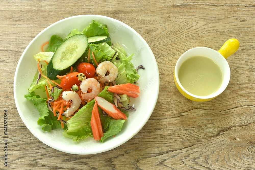 boiled shrimp and crab stick with vegetable seafood salad on plate dressing cream sauce