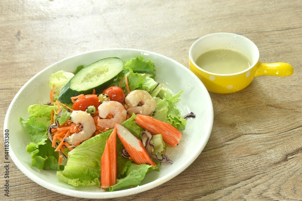 boiled shrimp and crab stick with vegetable seafood salad on plate dressing cream sauce