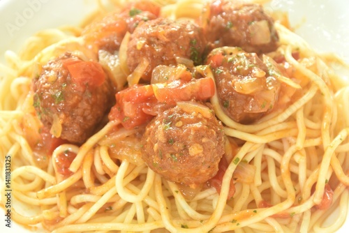 Obraz na płótnie spaghetti dressing fried meatball stuffed cheese in chop onion and tomato ketchup sauce on plate w salonie
