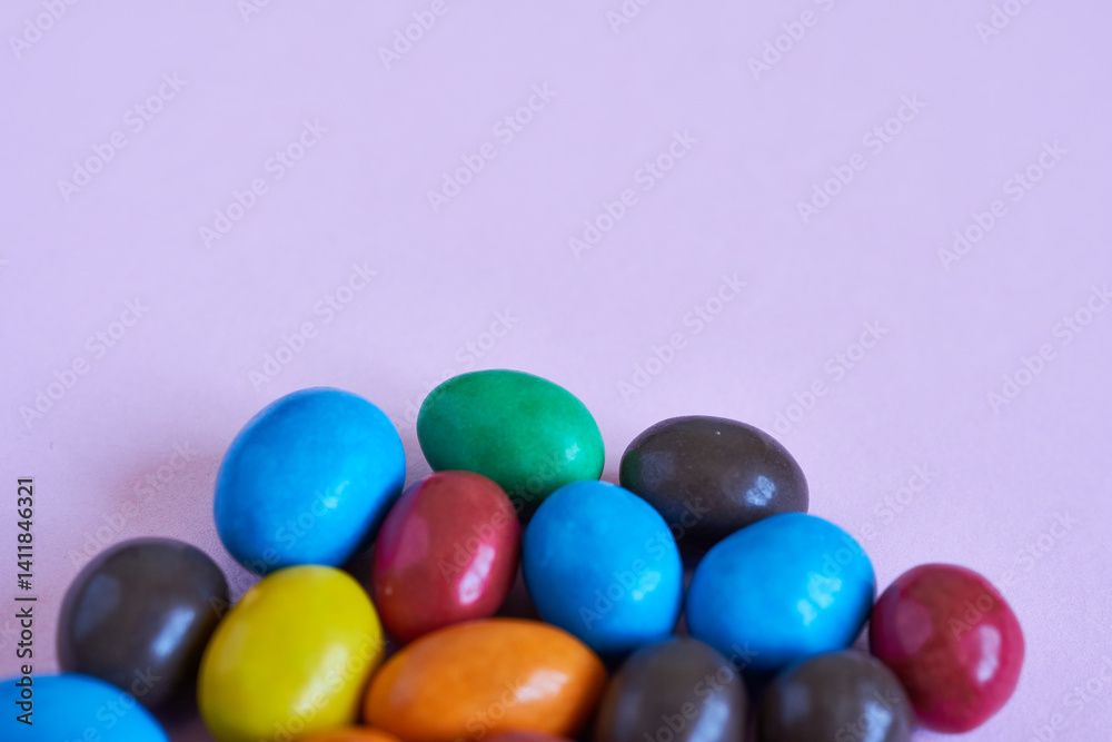 Colorful candies on pastel pink background. Top view. Colorful candies on pastel pink background. Top view.
